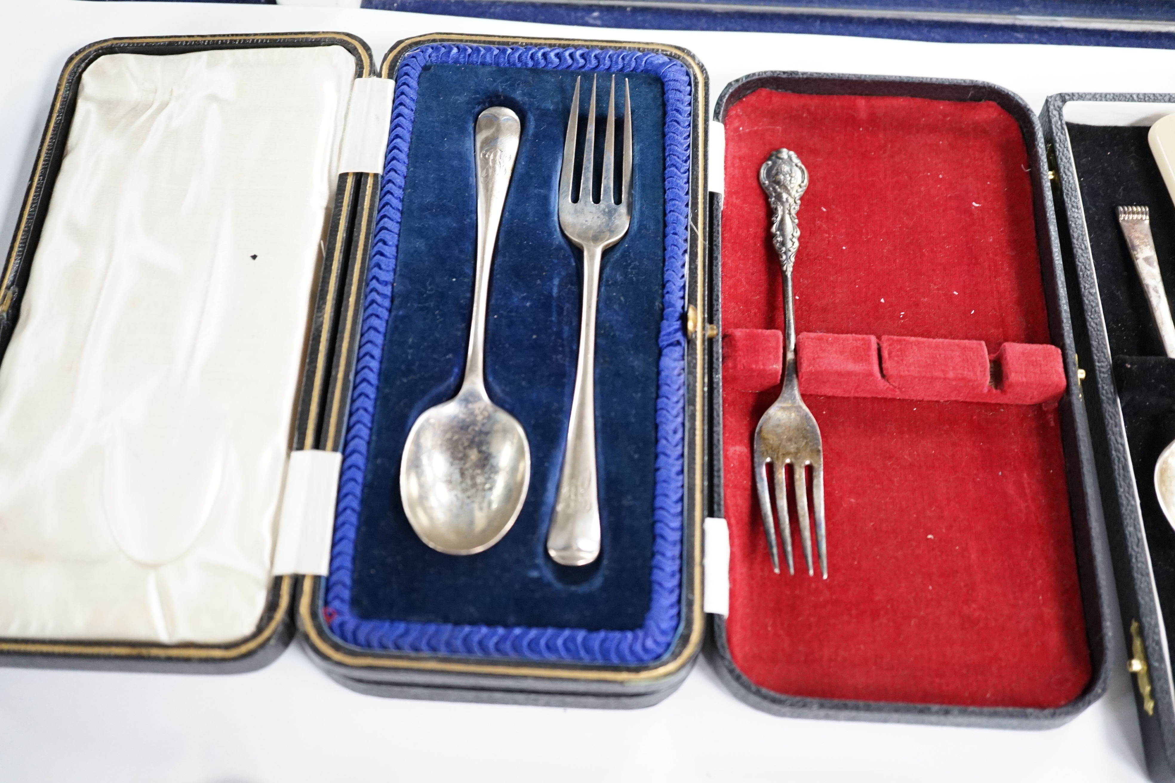A cased set of six mid 20th century silver teaspoons, a cased silver spoon and pusher, two cased silver christening sets, a boxed silver spoon and one other incomplete cased set. Condition - poor to fair
